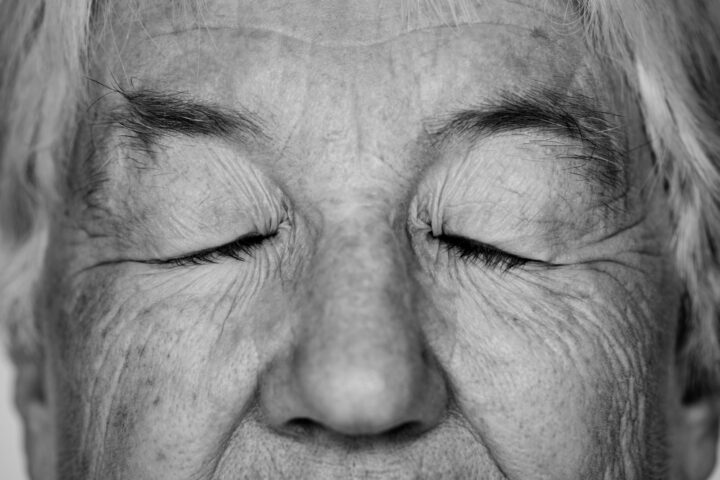 old woman with eyes closed