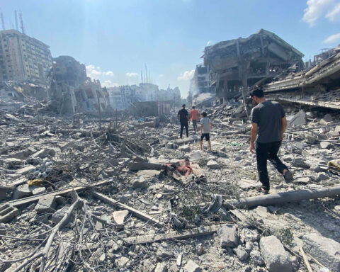 Palestinians inspect the damage following an Israeli airstrike on the El-Remal aera in Gaza City on October 9, 2023. Israel continued to battle Hamas fighters on October 10 and massed tens of thousands of troops and heavy armour around the Gaza Strip after vowing a massive blow over the Palestinian militants' surprise attack. Photo by Naaman Omar apaimages