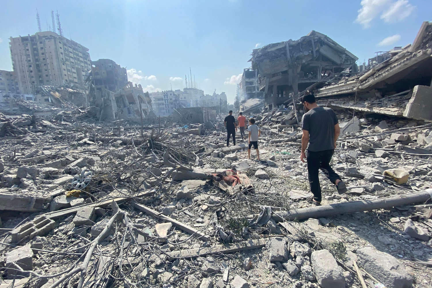 Palestinians inspect the damage following an Israeli airstrike on the El-Remal aera in Gaza City on October 9, 2023. Israel continued to battle Hamas fighters on October 10 and massed tens of thousands of troops and heavy armour around the Gaza Strip after vowing a massive blow over the Palestinian militants' surprise attack. Photo by Naaman Omar apaimages