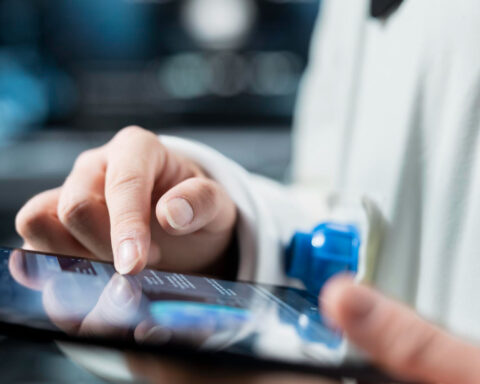 Close up of astronaut reviewing spacecraft metrics on tablet