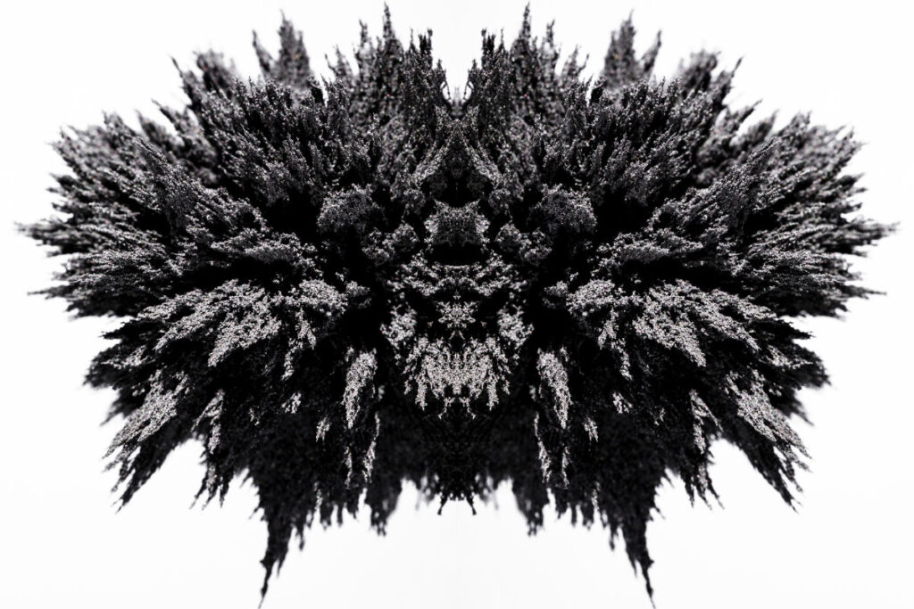 Symmetry magnetic metal shaving on white backdrop