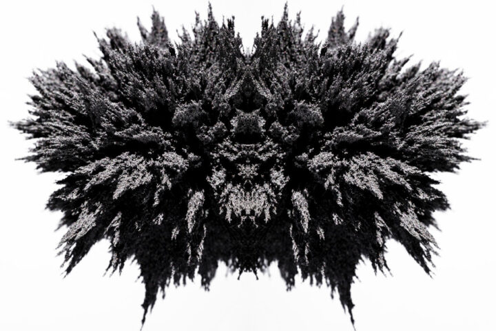 Symmetry magnetic metal shaving on white backdrop