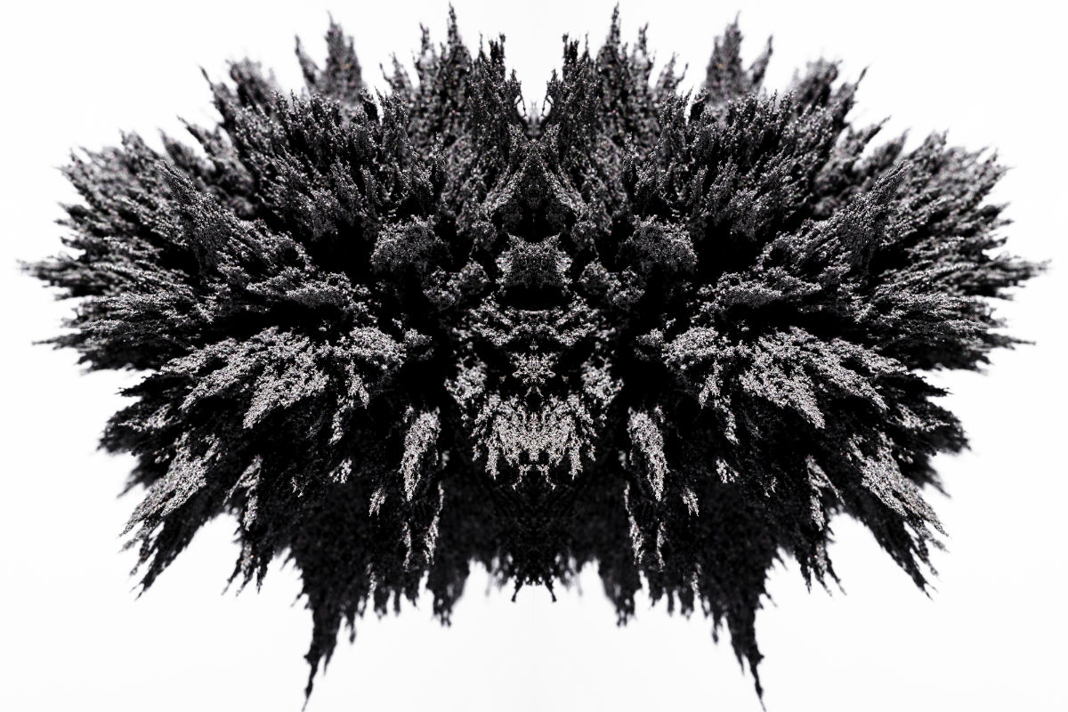 Symmetry magnetic metal shaving on white backdrop