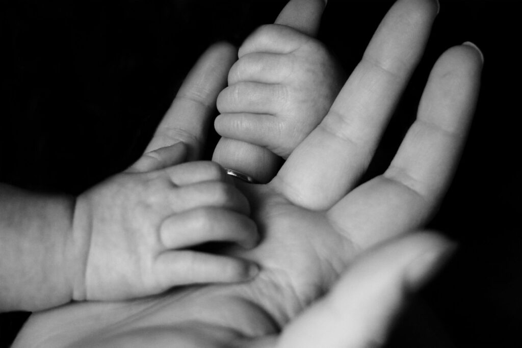 Hands of mother and baby