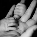Hands of mother and baby