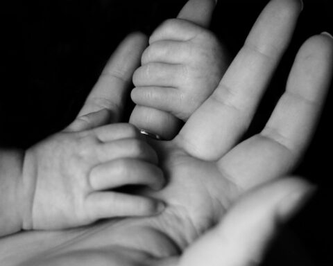 Hands of mother and baby
