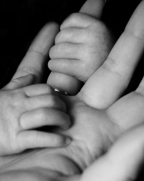 Hands of mother and baby